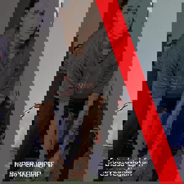 28 kg cast iron kettlebell with embossed weight, featuring a sleek black finish, held by a person in workout attire in a gym setting