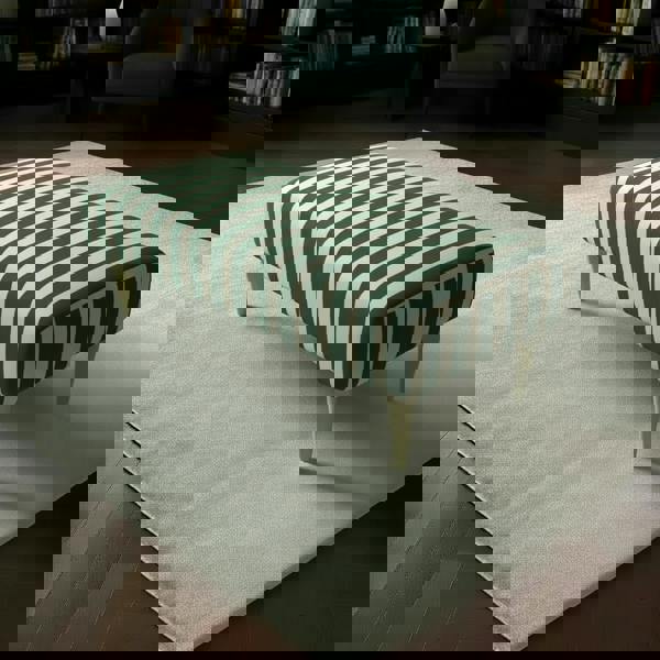 Long cushioned bedroom seat with seamless upholstered design and elegant wooden legs