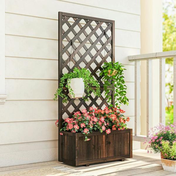 Carbonized wood garden planter with trellis and blooming flowers in raised wooden box