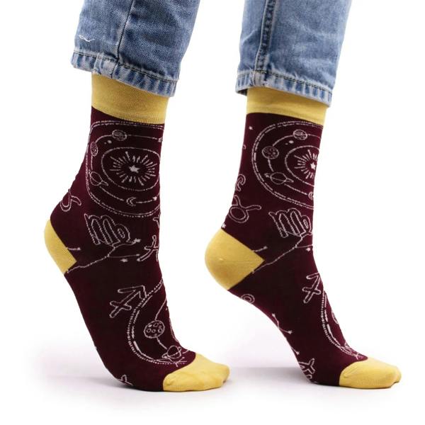 Burgundy bamboo crew socks with zodiac icons; mustard heel and toe panels.