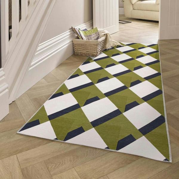 Geometric patterned rug on a wooden floor with a basket and books in the background.