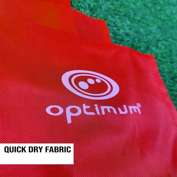 Close-up of red Optimum corner flag fabric with white logo on grass, Quick Dry Fabric text - Optimum