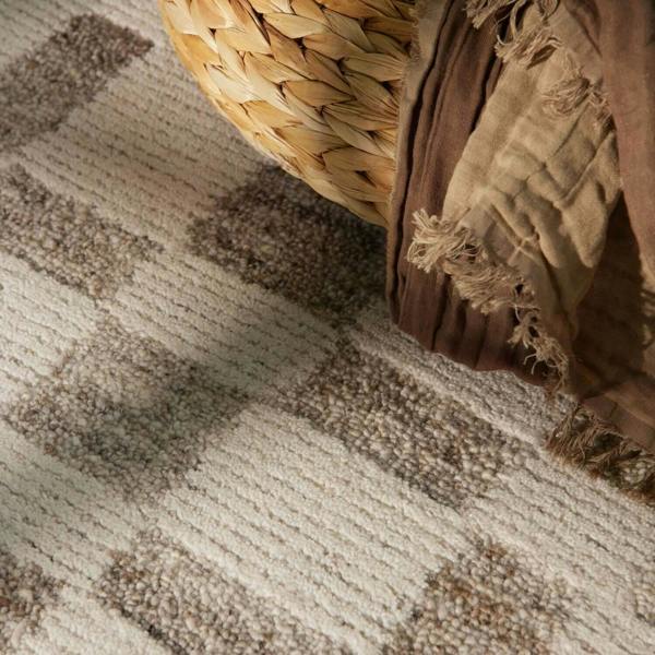 Woven basket and textured fabric on a patterned carpet