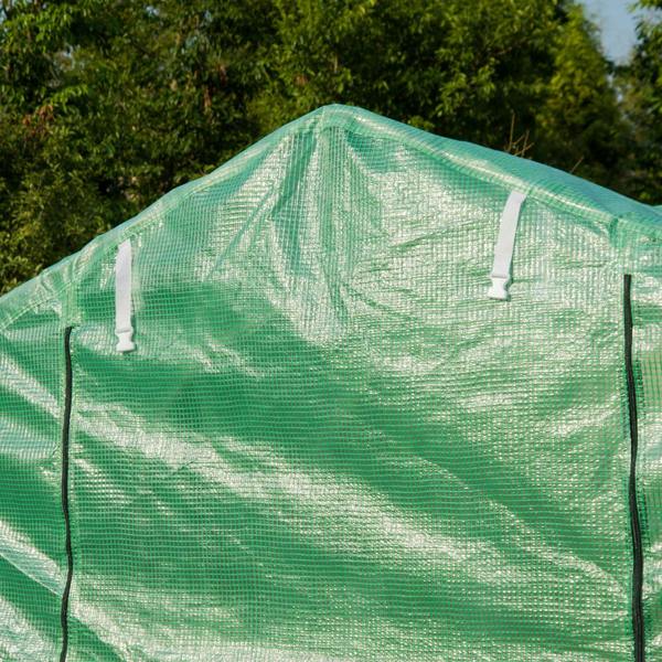 Green mesh roof and arched metal frame of a walk-in polytunnel greenhouse