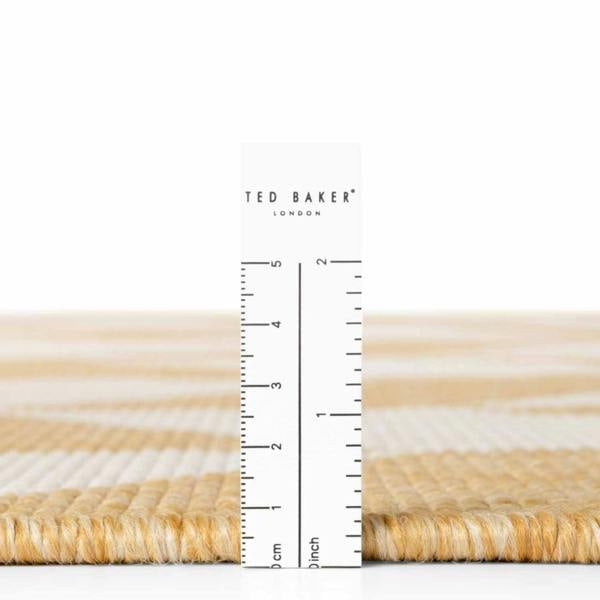 Measurement of a woven material with a ruler and 'Ted Baker' branding.