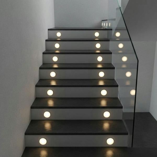 stair tread light mounted on stair risers of a modern indoor staircase