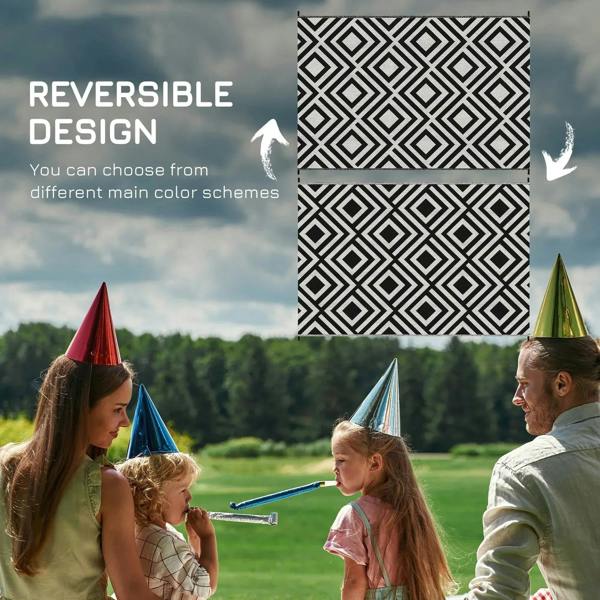 Black and white reversible outdoor rug featuring bold diamond geometric pattern