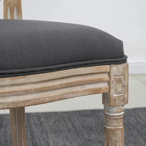 Grey upholstered dining chair side with thick cushion and distressed wood frame