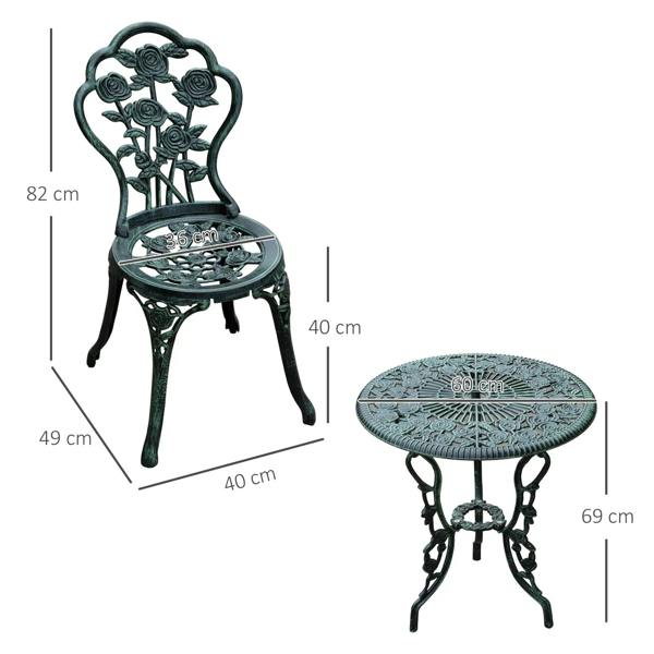 Antique green bistro chair with floral back and round cast tabletop with parasol hole.