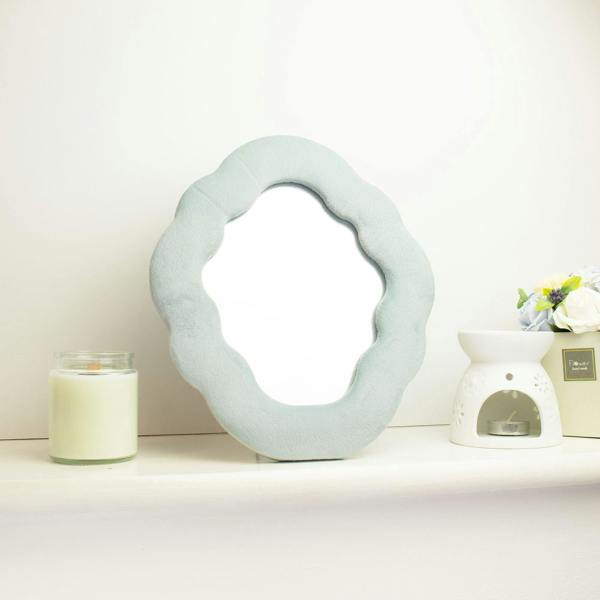 Cloud-shaped squiggly mirror in cloud blue, arched cutout reflective center