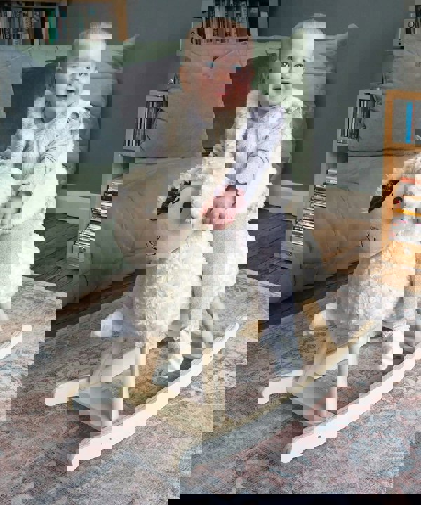 Little girl riding Lambert Lamb rocking horse 