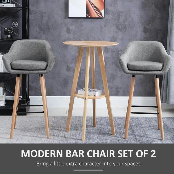 Set of 2 grey upholstered bar stools with rounded seats, wood legs, black footrests