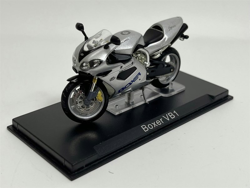 a small silver motorcycle on a black stand