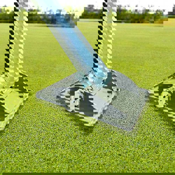 Image of a jack pad underneath a caravan leg on green grass