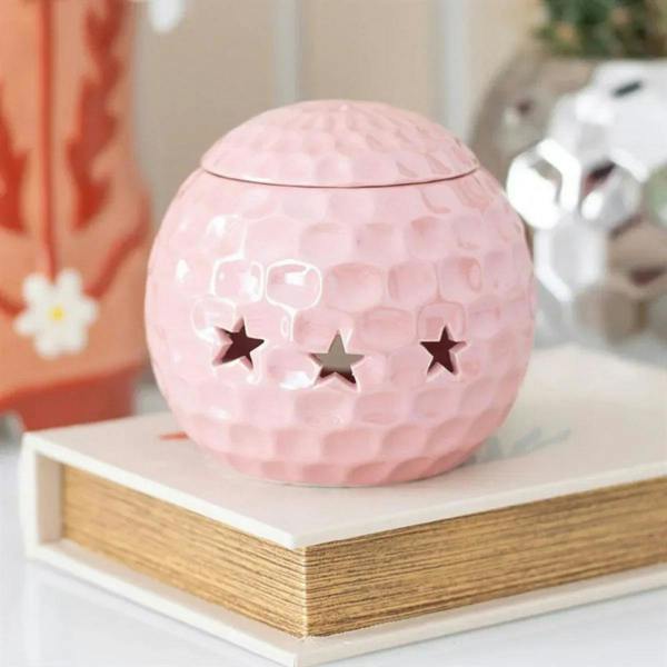 Pink disco ball-style oil burner with star cutouts and domed lid