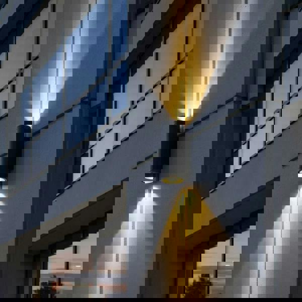 black large outdoor wall light mounted on the exterior wall of a commercial building