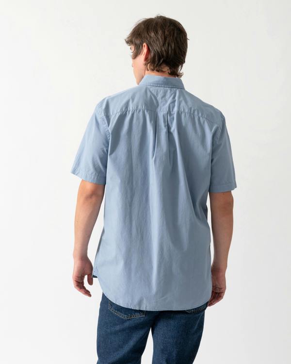 back shot of a model wearing a Tommy Hilfiger GMD Poplin Mens Short Sleeve Shirt in Brisk Blue