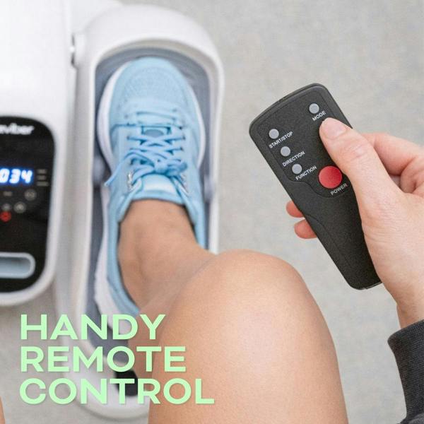 Someone uses a black remote with their foot, in a blue sneaker, inside the Reviber Motorised Mini Elliptical Bike by Reviber—perfect for seated exercise. “HANDY REMOTE CONTROL” appears in the lower left corner.