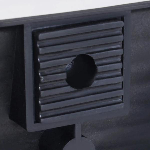 Close-up of black plastic car ramp interlocking notch with round peg and tread grooves