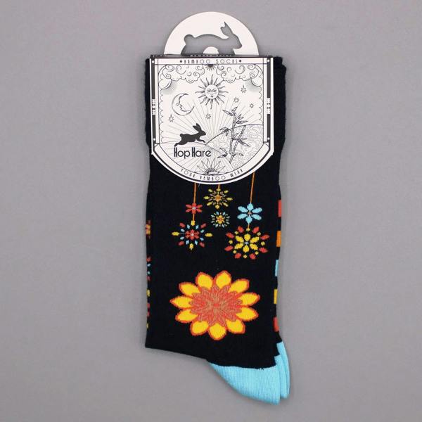 Black crew sock with colorful mandala flowers and geometric accents, light blue toe