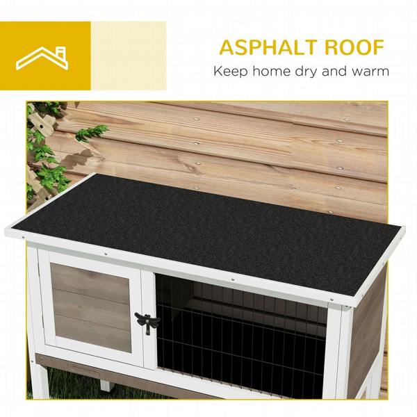 Brown wooden guinea pig hutch with asphalt roof panel over wire-mesh front