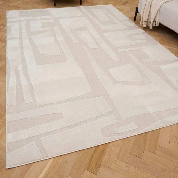 Beige area rug with geometric pattern on a wooden floor