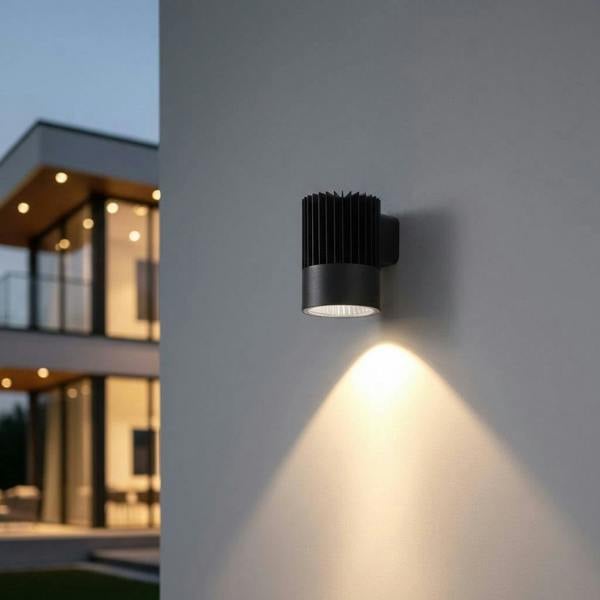 black large outdoor wall downlight mounted on the exterior white wall of a modern home 