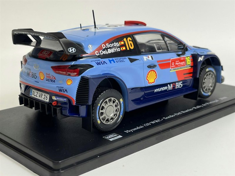 a blue race car on a black stand