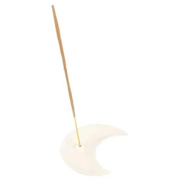 White crescent moon incense holder with incense stick inserted