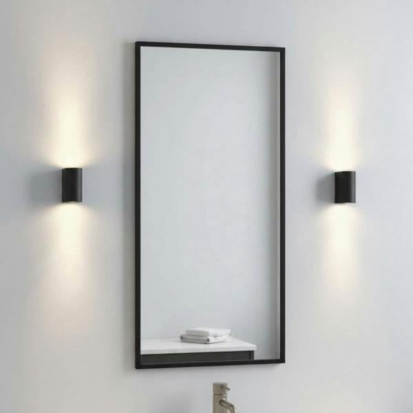 black bathroom wall mount light fitting mounted either side of a bathroom mirror