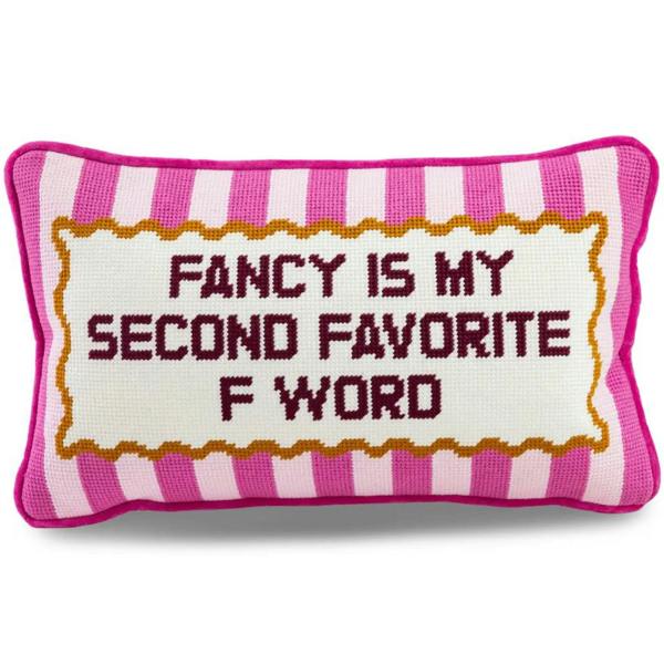 A rectangular hand-stitched needlepoint cushion with pink and light pink vertical stripes, displaying the text "FANCY IS MY SECOND FAVORITE F WORD" inside a gold scalloped border on a plain white background.