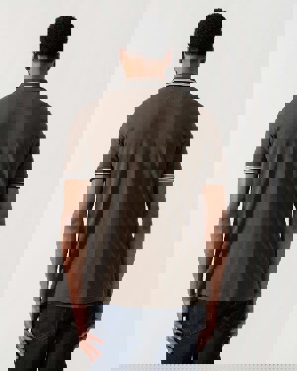 Model wearing BOSS Green Mens Paddy Cotton-Piqué Polo Shirt with Contrast Logo in Open Beige 297 - back