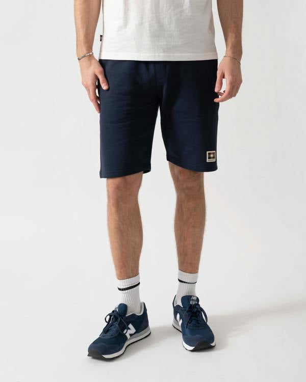 Studio shot of a model wearing a Aquascutum Mens Badge Shorts in Navy 11