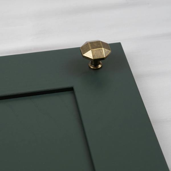 A 32mm diameter antique brass octagonal knob