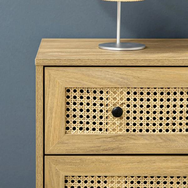 Close-up of rattan drawer front with black knob on wood-effect cabinet