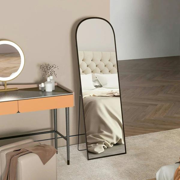 Black full-length leaning mirror with arched top and slim metal border