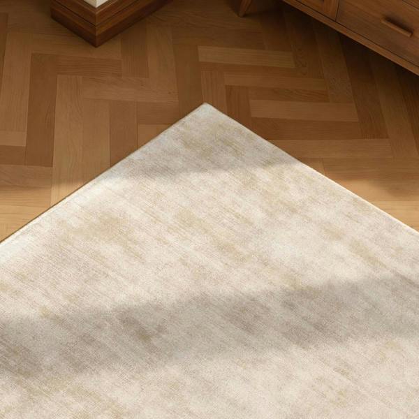 Beige rug on a wooden floor