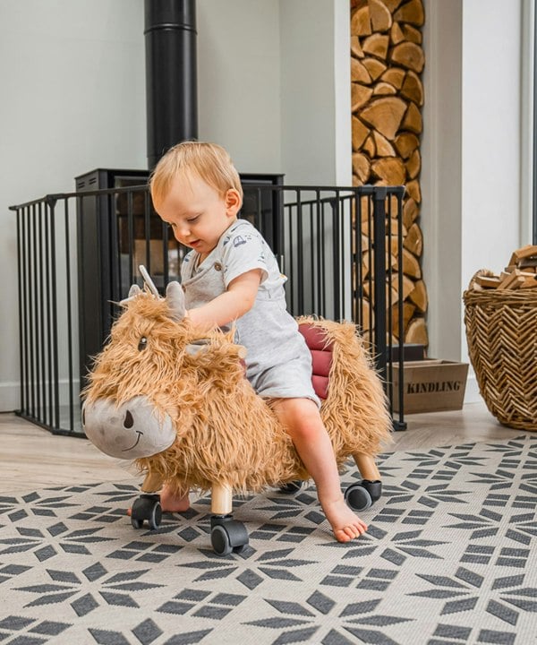 Toddler boy playing on Hubert Ride On Cow 