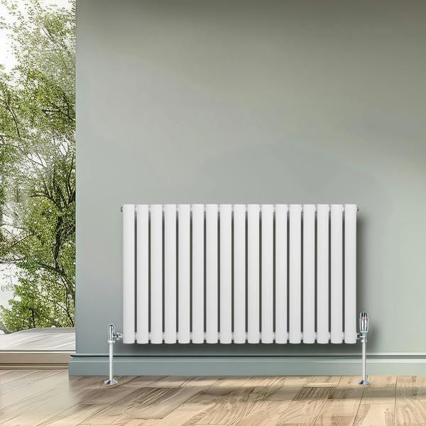 Oval single column radiator in sleek white finish, 600 x 1020mm, mounted on a wall, complementing a modern interior with natural light