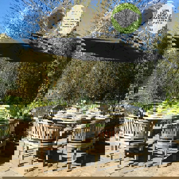 Black cantilever parasol with a square base, featuring a sleek design and durable fabric, providing ample shade over a round dining table set in a garden