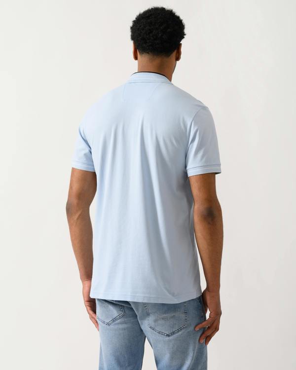 back shot of a Model wearing a BOSS Green PL_Member Mens Short Sleeve Polo Shirt in Open Blue 460