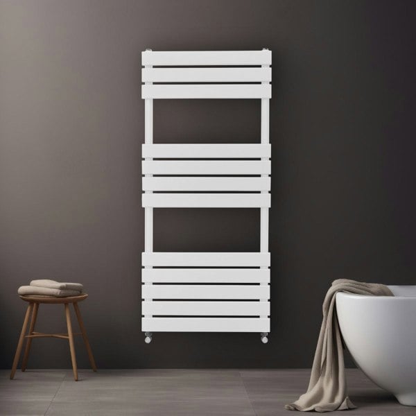 Flat panel towel radiator in white, 1200mm x 500mm, featuring sleek horizontal slats, mounted on a dark wall with a cozy towel draped nearby