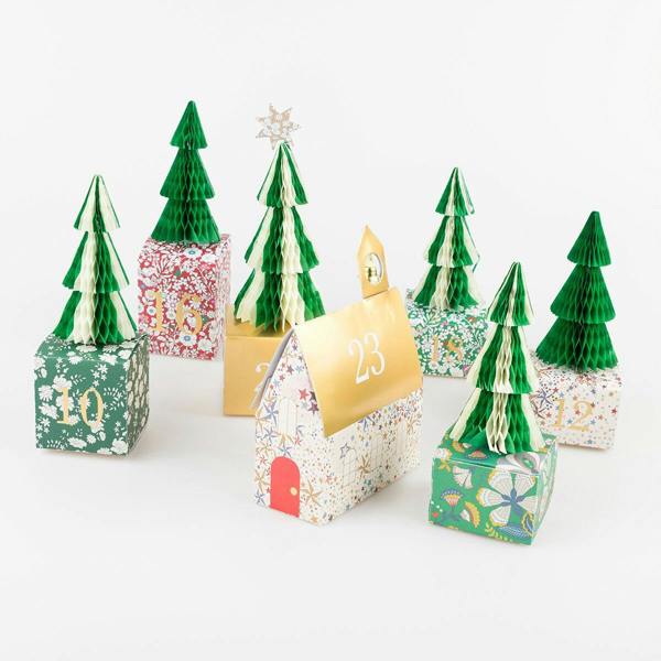Close-up of Liberty print advent calendar boxes featuring 3D tissue paper honeycomb trees and the church building box with gold foil roof.