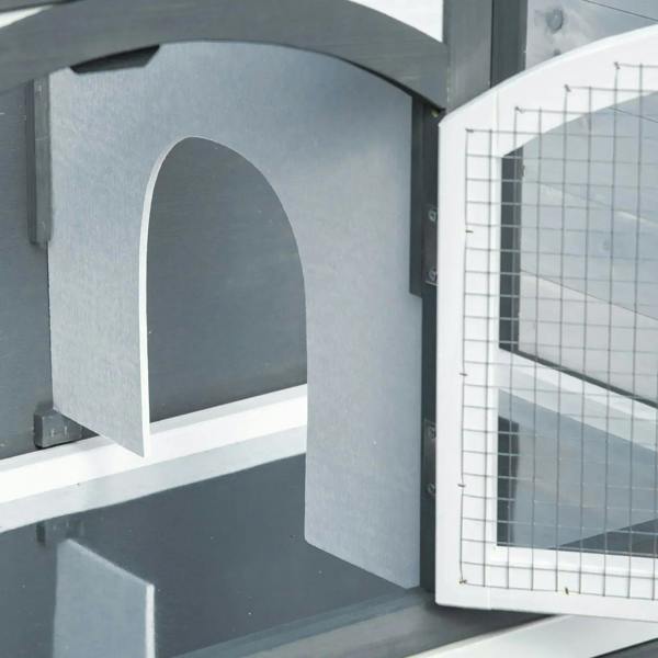 Close-up of grey arched tunnel entrance on a 2-tier rabbit hutch with wire mesh door