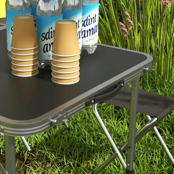Black aluminium picnic table corner with foldable stool beside it in outdoor grass