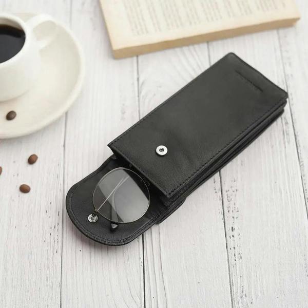Flat lay of Black leather double glasses case with two pairs of glasses