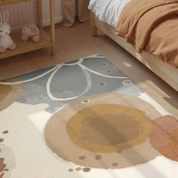 Children's room with a patterned rug featuring abstract shapes and colors.