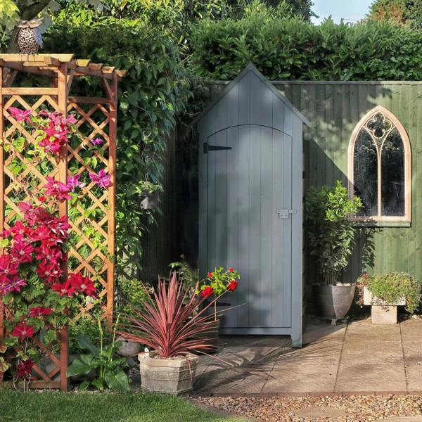 Grey wooden outdoor storage shed with tilt roof and lockable door in a garden setting