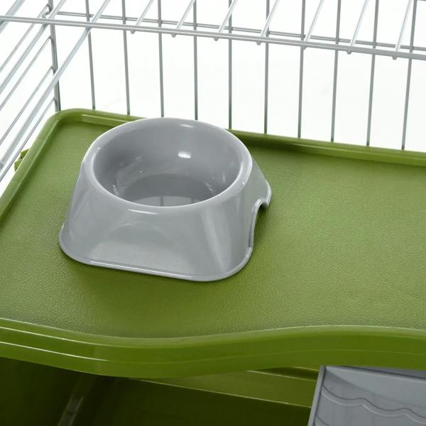 Gray water dish on green base inside a wire small animal cage