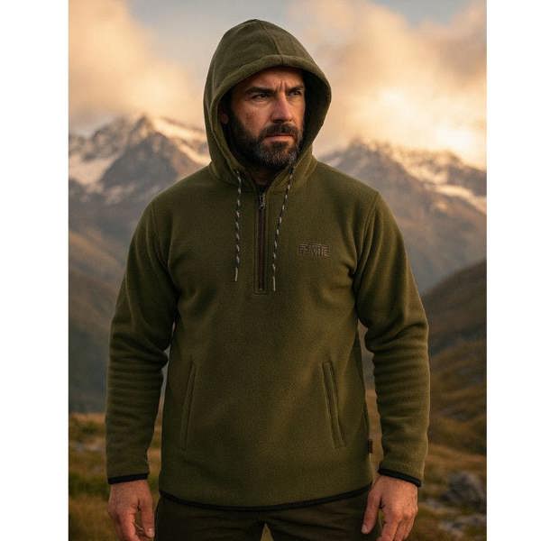 Man on mountains wearing the Game Alpine fleece hoodie to keep warm